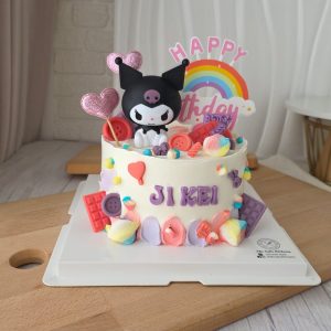 Kuromi pastel birthday cake with rainbow topper, candy decorations