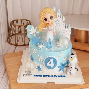 Frozen Elsa theme custom birthday cake with snowflake decorations, Elsa character topper in Puchong Selangor by The Cake Alchemy