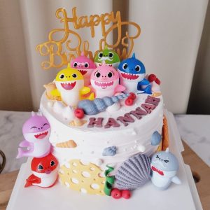 Baby Shark theme custom birthday cake with shark family toppers, ocean decorations and personalized name in Puchong Selangor by The Cake Alchemy