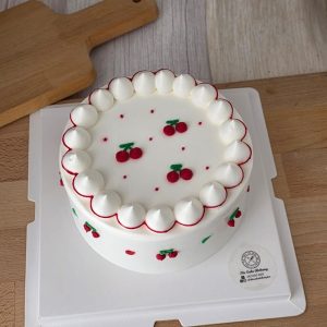 Minimalist cherry vintage style birthday cake with white fresh cream and red piping details in Puchong Selangor by The Cake Alchemy