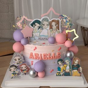 Huntrix K-pop theme birthday cake with character toppers and pastel decorations in Puchong Selangor by The Cake Alchemy