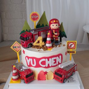 Fireman theme custom birthday cake with firefighter topper, fire truck decorations and personalized name in Puchong Selangor by The Cake Alchemy
