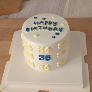 Minimalist vintage Korean-style birthday cake with blue and cream piped numbers and “Happy Birthday” lettering by The Cake Alchemy in Puchong Selangor Malaysia