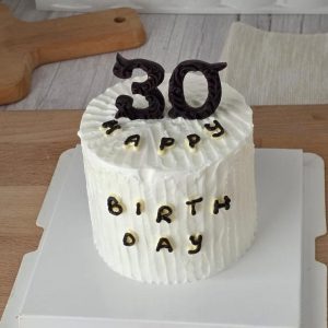 Minimalist 30th birthday cake with textured white cream frosting, dark chocolate number topper, and Korean vintage style design by The Cake Alchemy in Puchong Selangor Malaysia