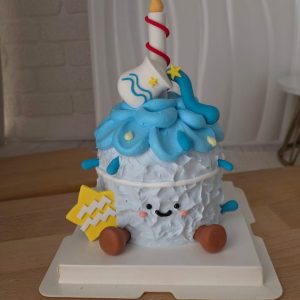 Aquarius Horoscope Jellycat Style birthday cake with fluffy blue whipped cream design, zodiac symbol decoration, candle topper, and cute smiling character aesthetic by The Cake Alchemy Puchong Selangor