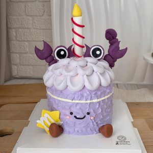 Scorpio Horoscope Jellycat Style Birthday Cake with pastel purple textured cream, cute smiling face, scorpion claw decorations, candle topper, and Scorpio zodiac symbol by The Cake Alchemy Puchong Selangor