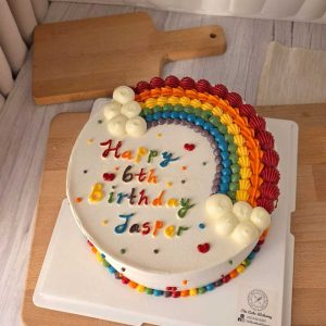 Colorful rainbow birthday cake with hand-piped rainbow decoration, fluffy cloud details, and personalized birthday message by The Cake Alchemy in Puchong Selangor Malaysia.