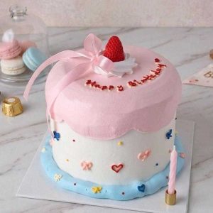 Minimalist pink strawberry birthday cake with handcrafted chocolate strawberry topper, satin ribbon, and Korean aesthetic decorations by The Cake Alchemy in Puchong Selangor Malaysia.