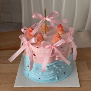 Pastel pink and blue strawberry ribbon cake with handcrafted chocolate strawberries, satin bows, and Korean vintage style decoration by The Cake Alchemy in Puchong Selangor Malaysia.