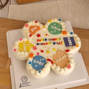 7-piece personalized cupcake set with colorful fondant name plaques, buttercream piping, and custom celebration message by The Cake Alchemy in Puchong Selangor Malaysia.