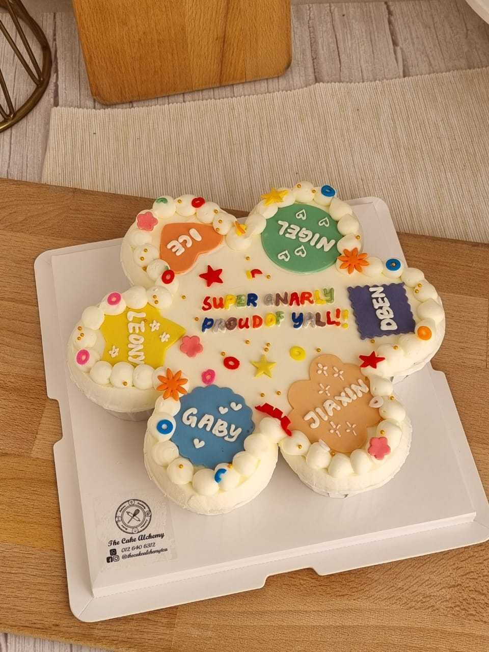 7-piece personalized cupcake set with colorful fondant name plaques, buttercream piping, and custom celebration message by The Cake Alchemy in Puchong Selangor Malaysia.