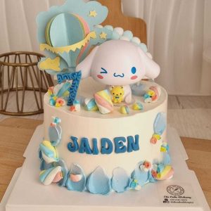 Cinnamoroll birthday cake with pastel blue cream, Sanrio character topper, rainbow decoration, and personalized name by The Cake Alchemy in Puchong Selangor Malaysia.