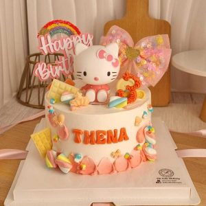 Hello Kitty birthday cake with pastel buttercream, Hello Kitty topper, rainbow decoration, colorful sweets, and personalized name by The Cake Alchemy in Puchong Selangor Malaysia.