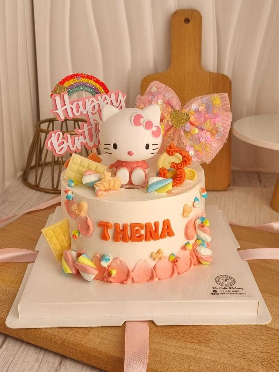 Hello Kitty birthday cake with pastel buttercream, Hello Kitty topper, rainbow decoration, colorful sweets, and personalized name by The Cake Alchemy in Puchong Selangor Malaysia.