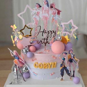 Huntrix themed birthday cake with pastel pink and lavender frosting, character toppers, holographic decorations, and personalized name by The Cake Alchemy in Puchong Selangor Malaysia.