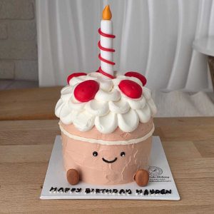 Jellycat-inspired birthday cake with a smiling cake character, fluffy whipped cream frosting, strawberry decorations, and birthday candle by The Cake Alchemy in Puchong Selangor Malaysia.