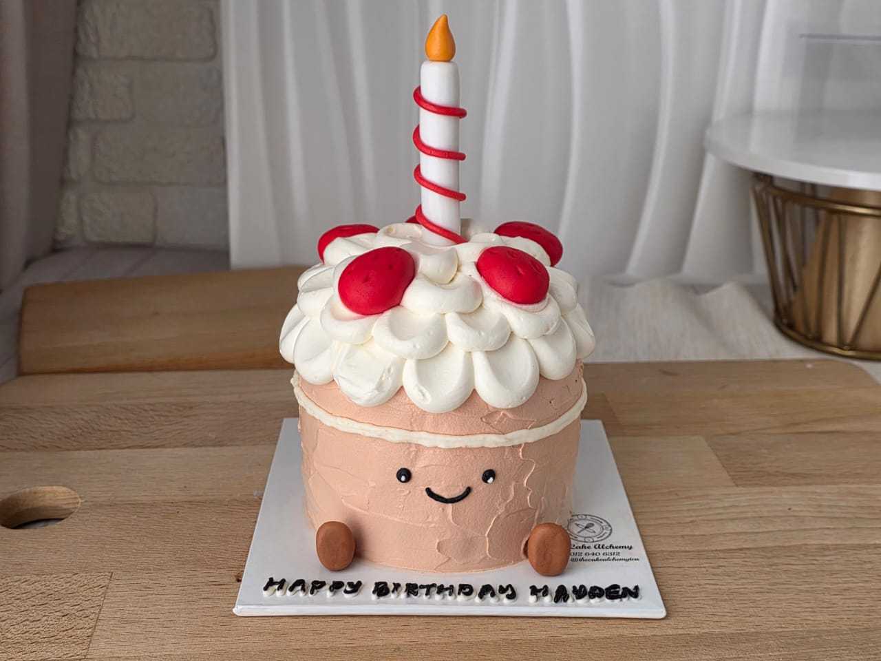 Jellycat-inspired birthday cake with a smiling cake character, fluffy whipped cream frosting, strawberry decorations, and birthday candle by The Cake Alchemy in Puchong Selangor Malaysia.