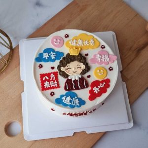 Chinese Blessings birthday cake with hand-piped cartoon portrait, colorful Chinese blessing plaques, cloud decorations, and cream finish by The Cake Alchemy in Puchong Selangor Malaysia.