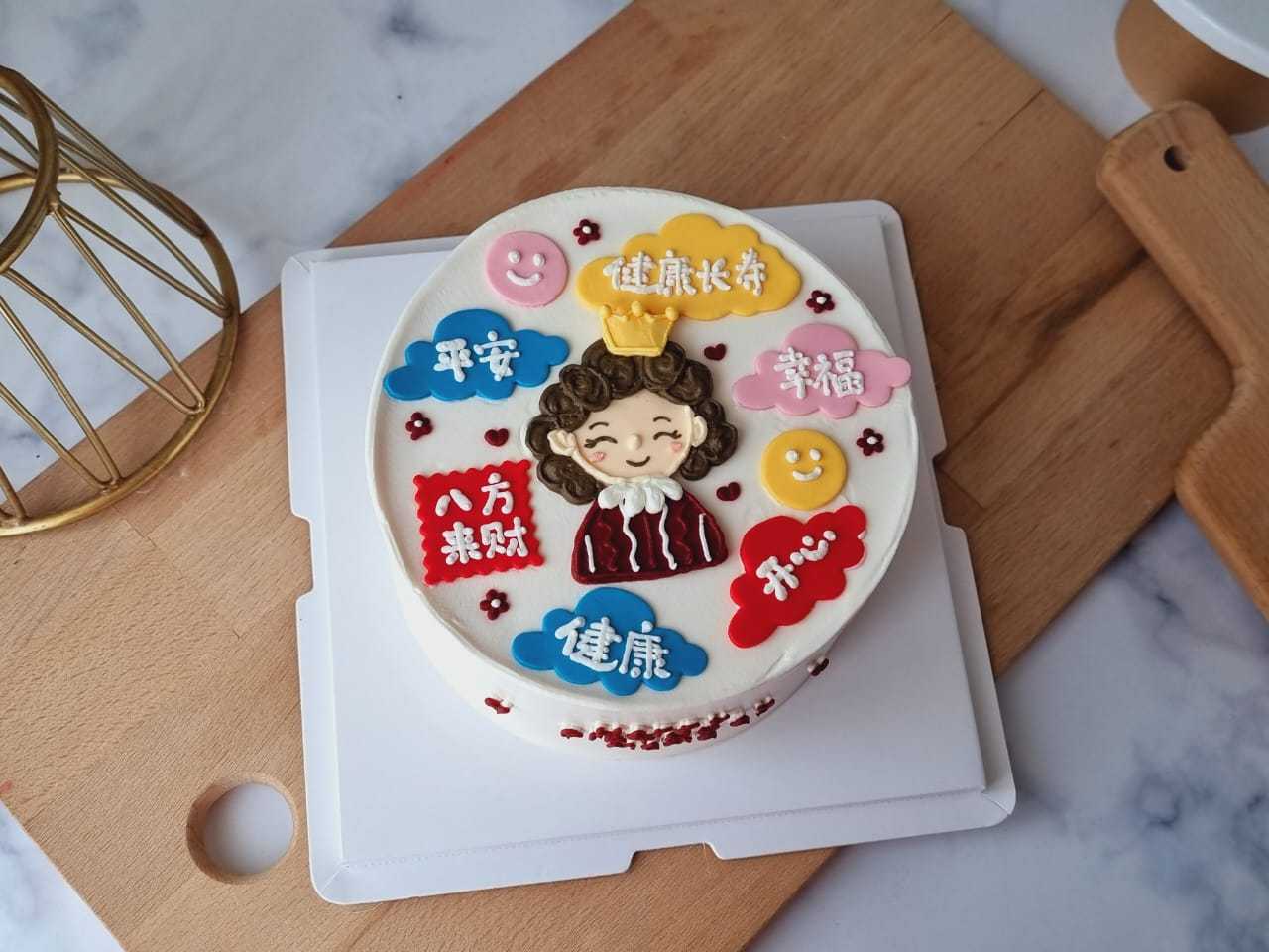 Chinese Blessings birthday cake with hand-piped cartoon portrait, colorful Chinese blessing plaques, cloud decorations, and cream finish by The Cake Alchemy in Puchong Selangor Malaysia.