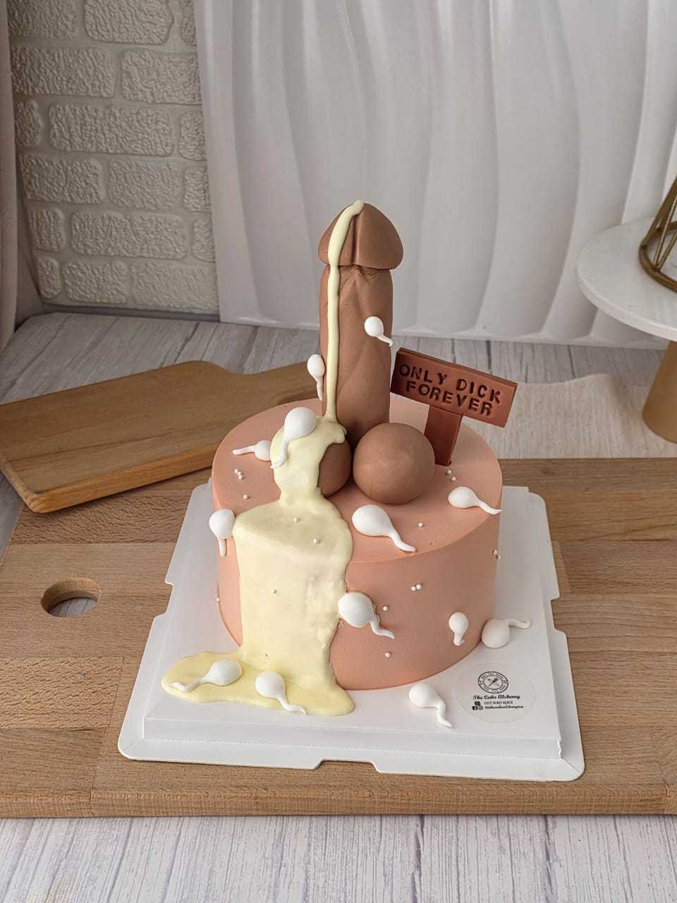 Naughty adult birthday cake with cheeky 3D decoration, cream details, and personalized message plaque by The Cake Alchemy