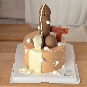 Naughty adult birthday cake with cheeky 3D decoration, cream details, and personalized message plaque by The Cake Alchemy